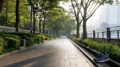 People walking along a quiet pavement in soft morning light.