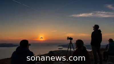 A low evening Sun partly covered by the Moon as eclipse viewers use protective glasses on a coastal hill.