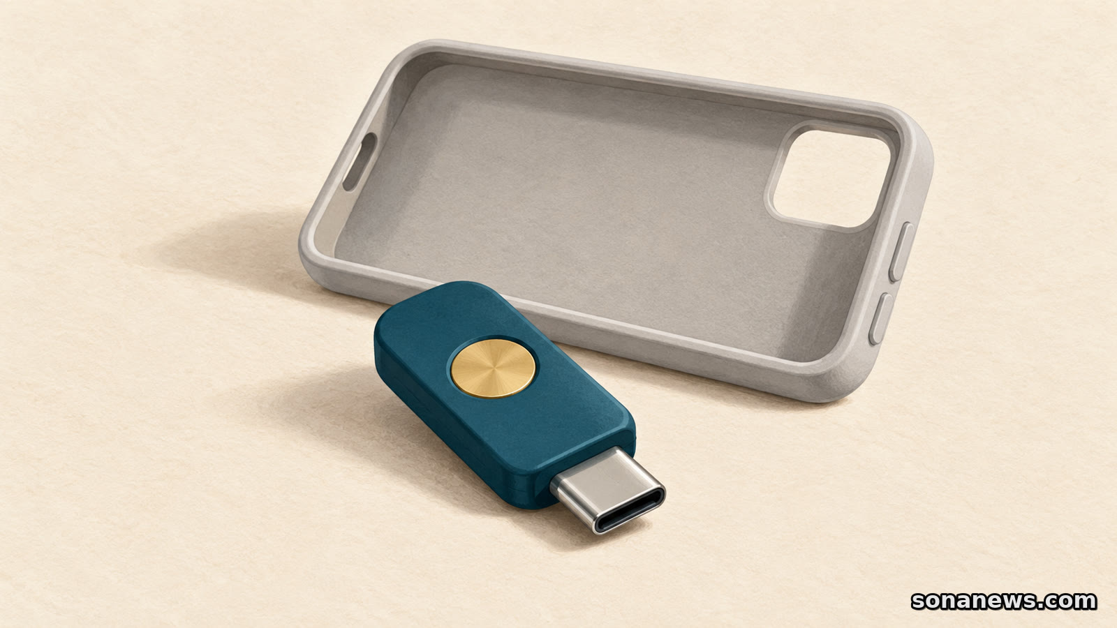 Une clé de sécurité USB-C à bouton rond devant une coque de téléphone vide, pour illustrer un accès de secours aux comptes.